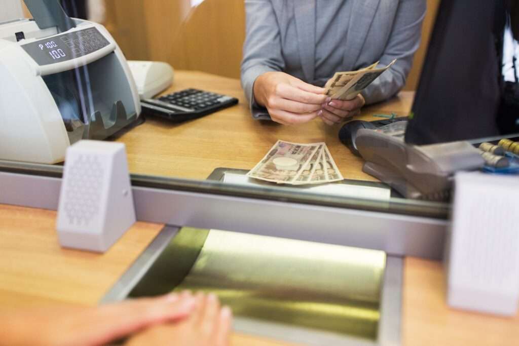 clerk counting cash money at bank office 2023 11 27 05 01 17 utc 1